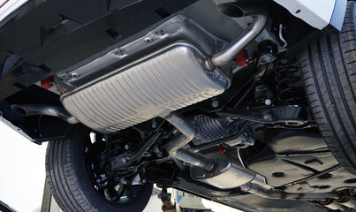 Fototapeta premium Modern powerful car on a lift in a car service.