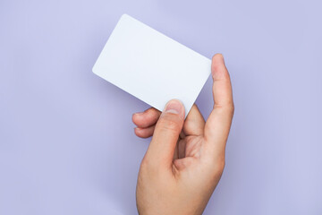 Obraz premium a right hand holding an empty white space on a lavender background. a mockup that is suitable for business or identity mockup use.