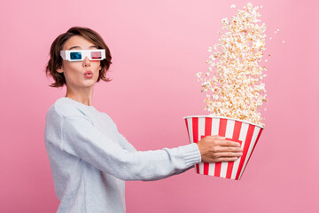 Photo of funky amazed positive happy young woman wear 3d glasses hold throw popcorn isolated on...