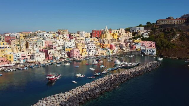 Aerial drone footage of the Procida typyical old town with its fisherman harbor in the bay of Napoli in Italy. Shot with a rotation motion. 