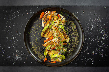 Chicken breaded fillet with zucchini, baby carrot and sprouts. Original presentation