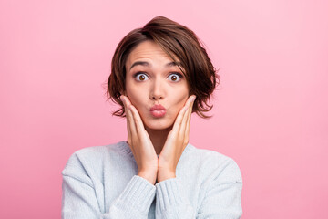 Photo of amazed shocked brunette haired happy young woman hold hand face send air kiss isolated on...