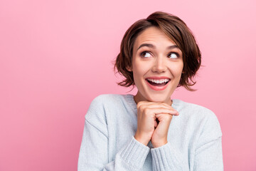 Photo of dreamy happy positive young woman look empty space imagine idea isolated on pink color background