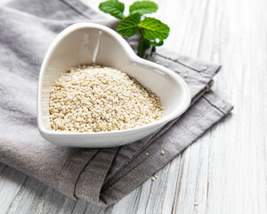 Sesame seeds in a bowl  on a rustic table