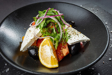 Traditional greek salad with fresh vegetables, feta cheese and olives.