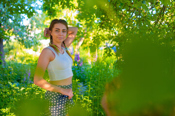 Woman model poses for a photographer in nature