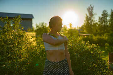 Woman model poses for a photographer in nature