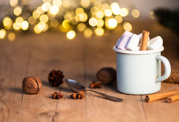 cup of hot chocolate  with marshmallows  cinnamon sticks  cones and branches of spruce. the concept of cozy Christmas and New Year holidays
