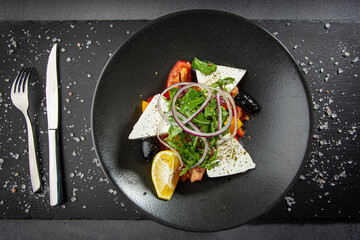 Traditional greek salad with fresh vegetables, feta cheese and olives.