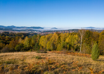 View of the tourist town of Zlatibor in the fog on the mountain Zlatibor in Serbia surrounded by peaks breaking through the morning fog in October