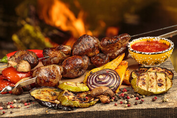 Shashlik or shish kebab preparing on barbecue grill over hot charcoal. Grilled pieces of pork meat on metal skewers.