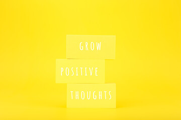 Positive affirmation or motivational quote concept. Grow positive thoughts written on yellow...