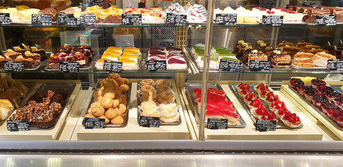 Showcase with sweets in a store in Kiev. Panorama of various sweets with prices.