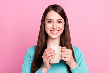 Portrait of attractive cheerful girl drinking beverage good mood caffeine isolated over pink pastel color background