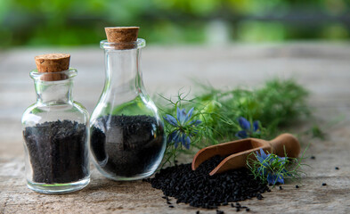 Black cumin oil in a bottle. Selective focus.