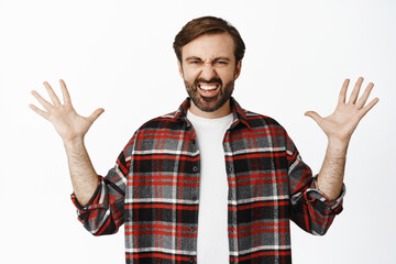 Enthusiastic bearded man spread hands sideways, showing something big, large sale promo deal, standing over white background