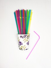 multicolored tubes in a glass with flowers
