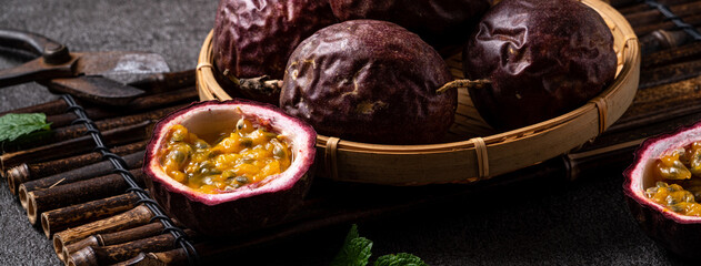 Delicious juicy passion fruit on gray table background.