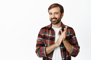 Image of smiling bearded man applausing, clap hands and smiling pleased, praise something good,...