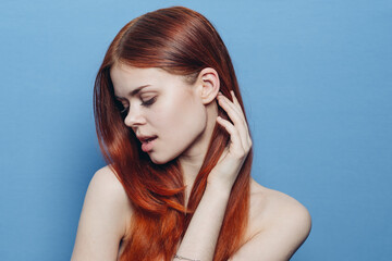 woman with bare shoulders red hair Glamor blue background