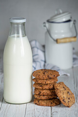 chocolate coockies next to a bottle of fresh milk. selective focus. handmade holiday biscuits