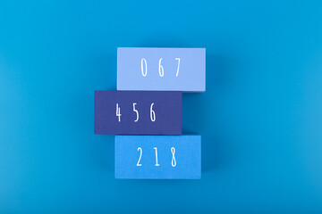 Squid Game Korean movie concept. People numbers 067, 456, 218 on rectangles on blue background
