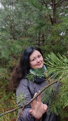 Young woman resting in a pine forest