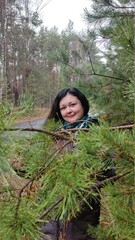 Young woman resting in a pine forest