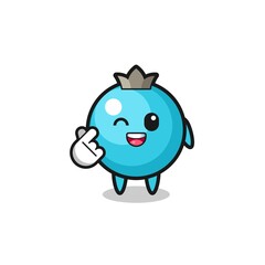 blueberry character doing Korean finger heart