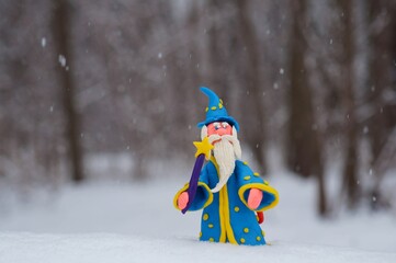 A toy wizard in a winter snow forest.
