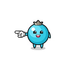 blueberry cartoon with pointing left gesture