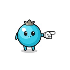 blueberry mascot with pointing right gesture