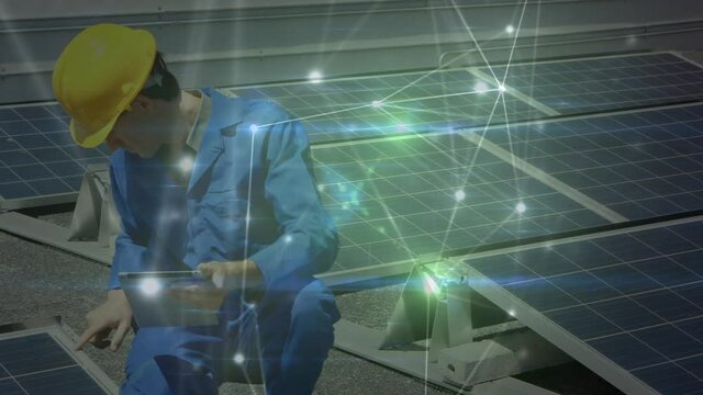 Animation of network of connections over solar panels and male engineer in background
