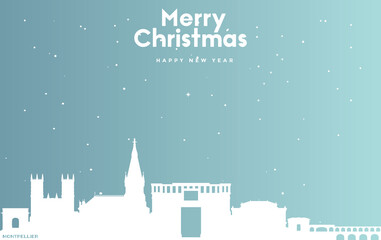 Christmas and new year blue greeting card with white cityscape of Montpellier