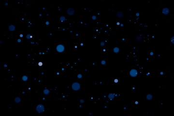 Blue defocused bokeh on a dark background.