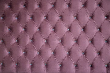 seamless texture of velvety purple fabric on upholstered furniture with glass crystals close-up, without people