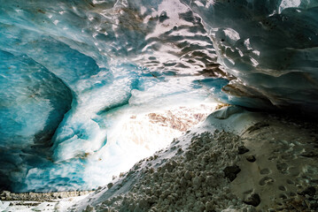 Zinal glacier cave with a river flowing in the middle in Switzerland