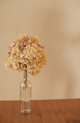 a bouquet of dry flowers on the wooden table