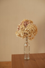 a bouquet of dry flowers on the wooden table