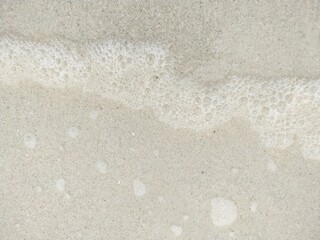 Image of a sandy beach with waves on the sea