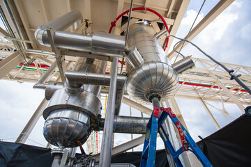Stainless vertical steel tanks and pipes with pressure meter in equipment tank chemical cellar at the with stainless steel tanks