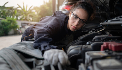 Mechanic changing engine, service car workshop automobile. professional female shop maintenance