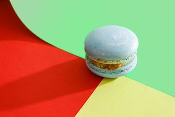 blue macaroon lies on a colored background