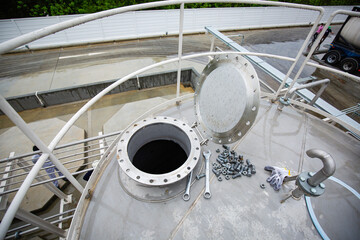 Manhole open lid stainless steel tank chemical methanol testing.