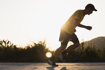backlit photograph of a running runner.