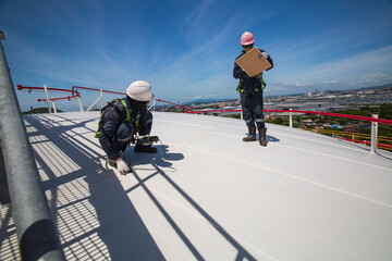 Male two worker are for inspection ultrasonic thickness roof plate top