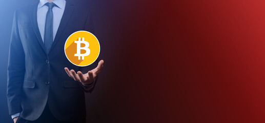 Male hand holding a bitcoin icon on blue background. Bitcoin Cryptocurrency Digital Bit Coin BTC Currency Technology Business Internet Concept.flat icons with long shadows.