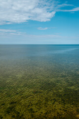 Obraz premium Aerial view over the Baltic sea from the Panga cliff in Saaremaa, Estonia during sunny day. the highest bedrock outcrop in western Estonia