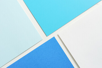 On a white background, an abstract background, notion of white and various hues of blue paper...