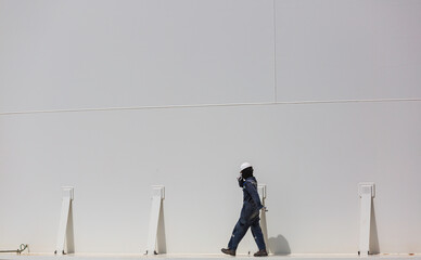 Male worker industry visual inspection storage tank gas